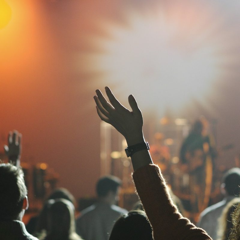 Worshippers with hands raised at a church service